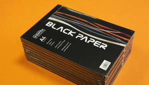 Stack of Seawhite pads containing black paper with cover designed by Toop Studio