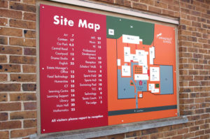 A sign on a brick wall showing a site map of school buildings - illustrating ‘S is for Signage’ in A to Z design for schools blog